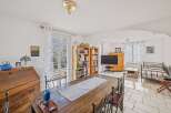 Discover the charm of this inviting property, featuring a spacious dining area perfect for gatherings.