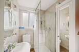 Step into this beautifully designed bathroom, featuring a modern shower and a convenient toilet.
