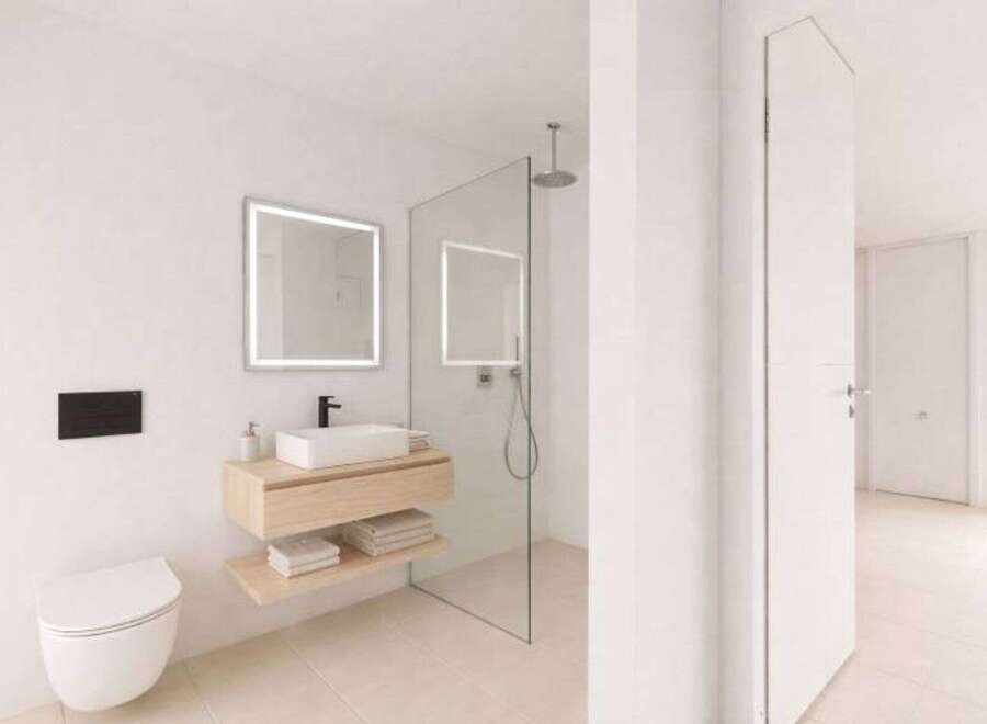 Step into a modern bathroom oasis! This stunning space features a sleek, floating vanity with a minimalist design, complemented by a stylish, illuminated mirror.