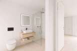 Step into a modern bathroom oasis! This stunning space features a sleek, floating vanity with a minimalist design, complemented by a stylish, illuminated mirror.
