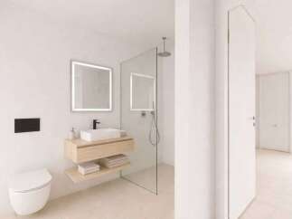 Step into a modern bathroom oasis! This stunning space features a sleek, floating vanity with a minimalist design, complemented by a stylish, illuminated mirror.