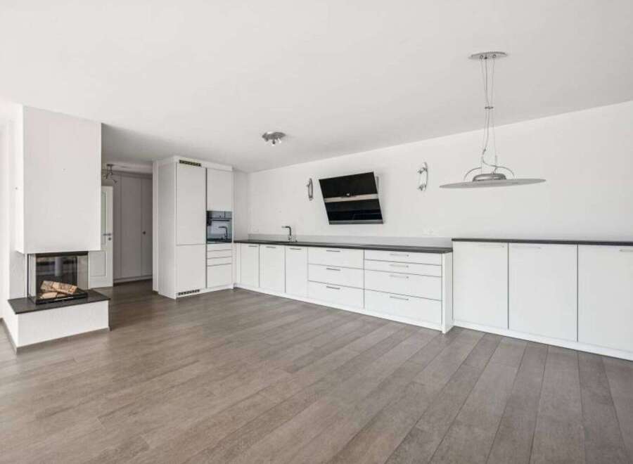 This modern living space boasts a sleek, minimalist design with a focus on functionality and style.
