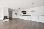 This modern living space boasts a sleek, minimalist design with a focus on functionality and style.