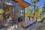 This stunning property boasts modern architecture with sleek lines and a beautiful wooden deck, perfect for outdoor entertaining.