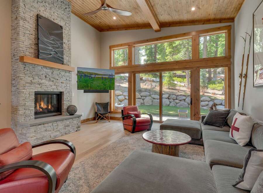 Experience luxury living in this stunning property featuring a cozy fireplace and a spacious living area.