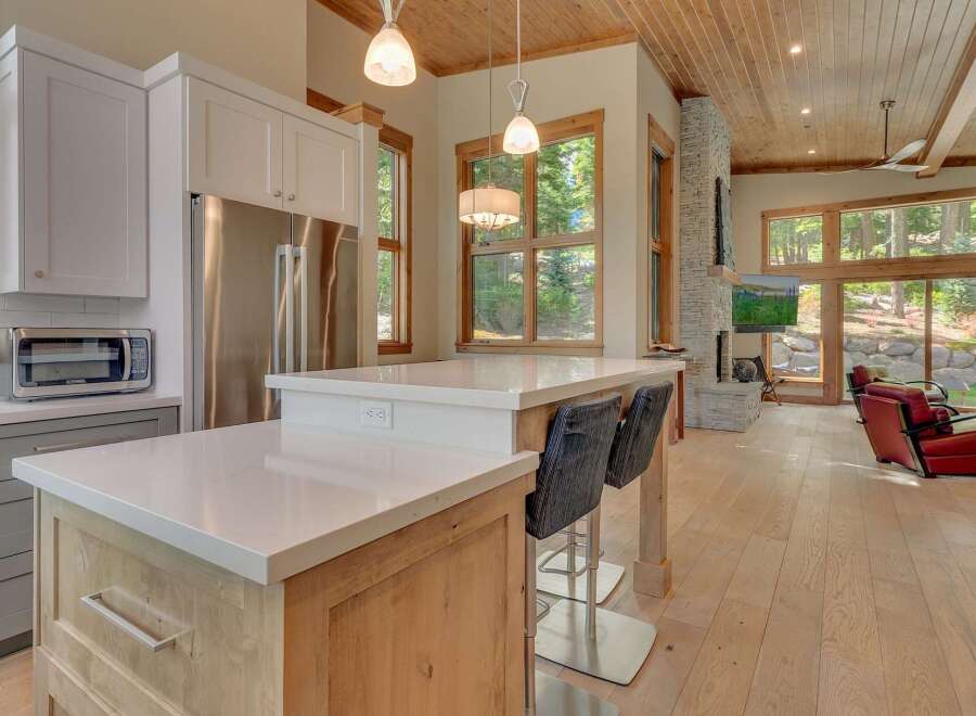 This stunning kitchen boasts a modern design with sleek countertops and stainless steel appliances.