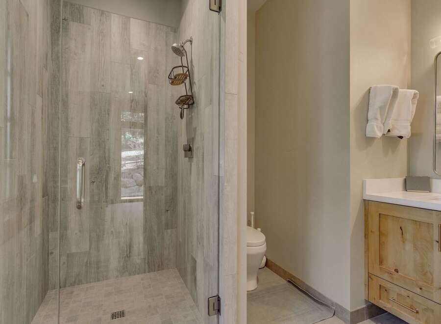 Step into luxury with this stunning bathroom! Featuring a beautifully tiled shower with a glass door, this space exudes modern elegance.