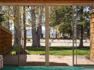 Enjoy stunning views from this property! This home features a beautiful outdoor space with a brick patio and lush green lawn.
