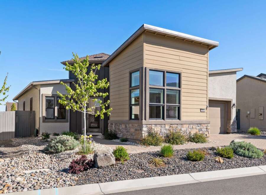 Discover modern living in this stunning property! This home boasts a contemporary design with a beautiful facade featuring stone accents and large windows.