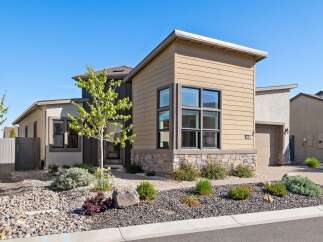 Discover modern living in this stunning property! This home boasts a contemporary design with a beautiful facade featuring stone accents and large windows.