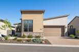This stunning modern home boasts a beautiful exterior with a combination of stone and siding.