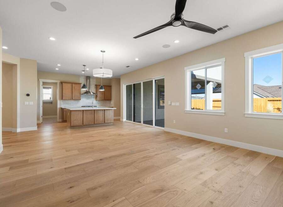 Step into this stunning open-concept living space, featuring beautiful hardwood floors and abundant natural light.