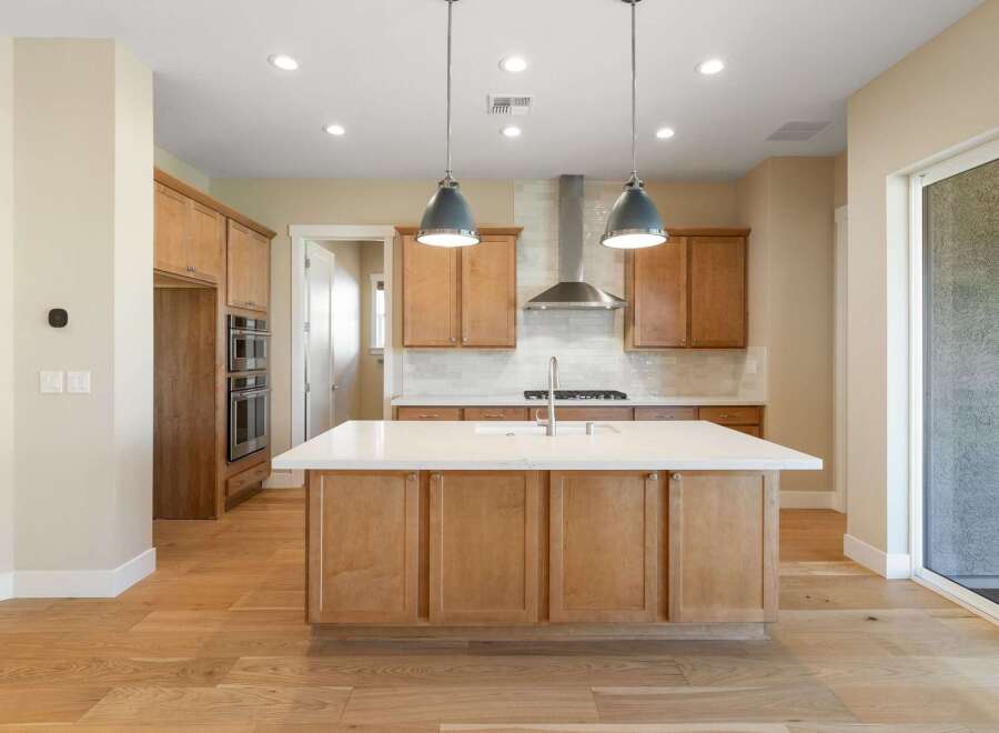 This stunning kitchen boasts a modern design with sleek cabinetry and a spacious island, perfect for culinary enthusiasts.