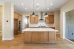 This stunning kitchen boasts a modern design with sleek cabinetry and a spacious island, perfect for culinary enthusiasts.
