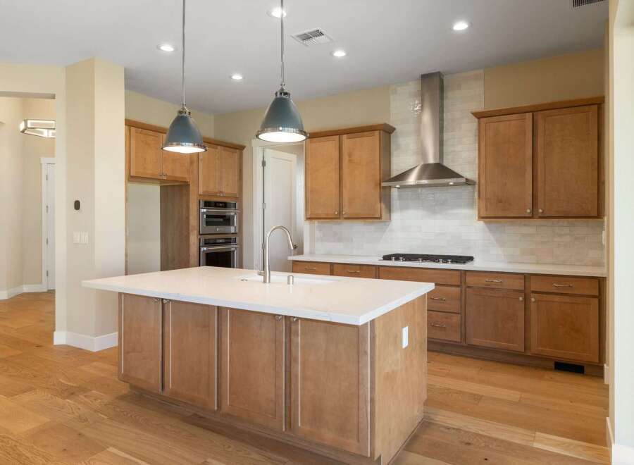 This stunning kitchen boasts a modern design with a spacious island, perfect for meal preparation and entertaining.