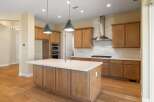 This stunning kitchen boasts a modern design with a spacious island, perfect for meal preparation and entertaining.