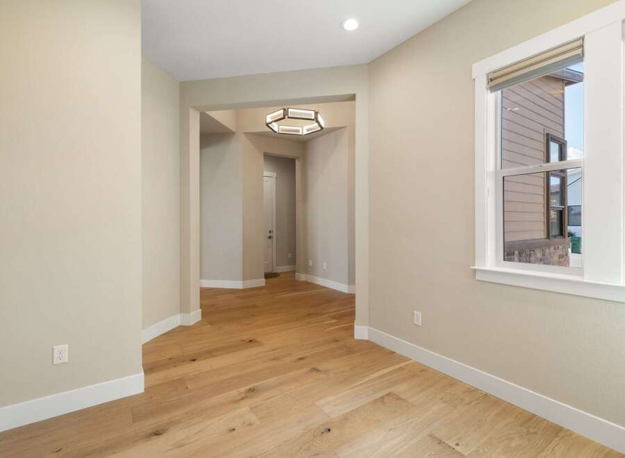 Step into this inviting space, showcasing beautiful hardwood floors that flow throughout.