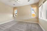 This inviting bedroom boasts a neutral color palette and ample natural light, creating a serene atmosphere.