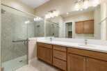 Step into luxury with this stunning bathroom, featuring a spacious glass-enclosed shower and elegant vanity.