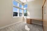 This bright and airy room features a large corner window that floods the space with natural light.