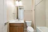 This beautiful bathroom features a modern vanity with a sleek countertop and a stylish faucet.