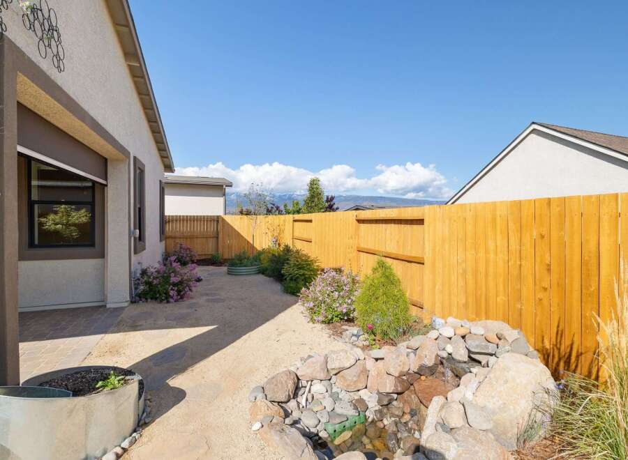 Discover your dream outdoor oasis with this stunning property! This backyard boasts a beautifully crafted water feature, perfect for relaxation and adding a touch of nature.