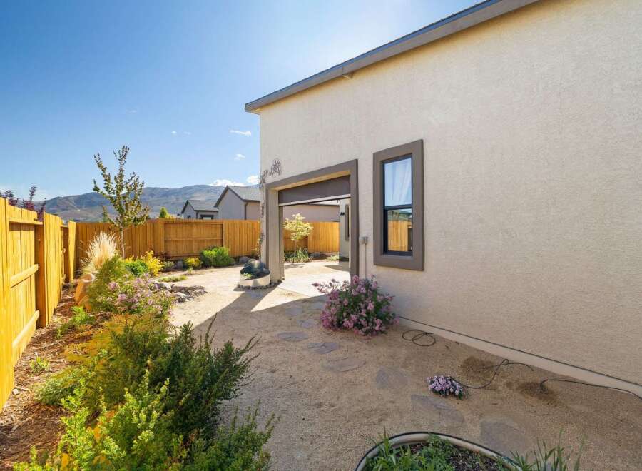 Discover the charm of this stunning property, featuring a beautifully landscaped backyard with a serene patio area.