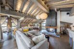 Experience luxury living in this stunning chalet, featuring a cozy living room with a fireplace and a spacious layout.