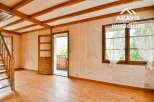 Discover the charm of this inviting property, featuring a warm wooden floor and exposed beams that create a cozy atmosphere.