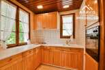 Discover the charm of this inviting kitchen, featuring warm wooden cabinetry and a bright, airy atmosphere.