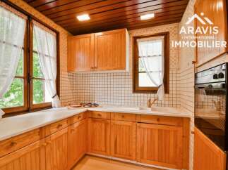 Discover the charm of this inviting kitchen, featuring warm wooden cabinetry and a bright, airy atmosphere.