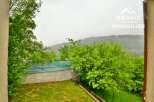 Discover a serene property nestled amidst lush greenery and breathtaking mountain views.