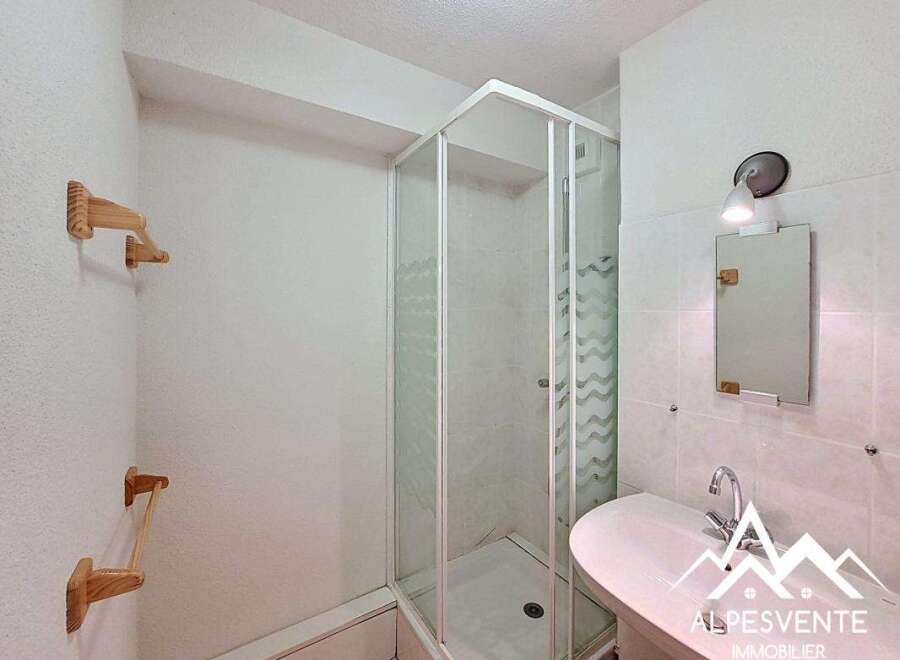 Discover this charming bathroom featuring a modern shower enclosure and a stylish sink.