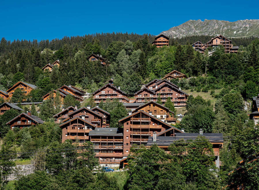 Nestled in a picturesque mountain setting, these charming wooden chalets offer a serene escape.