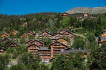 Nestled in a picturesque mountain setting, these charming wooden chalets offer a serene escape.