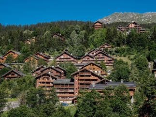 Nestled in a picturesque mountain setting, these charming wooden chalets offer a serene escape.