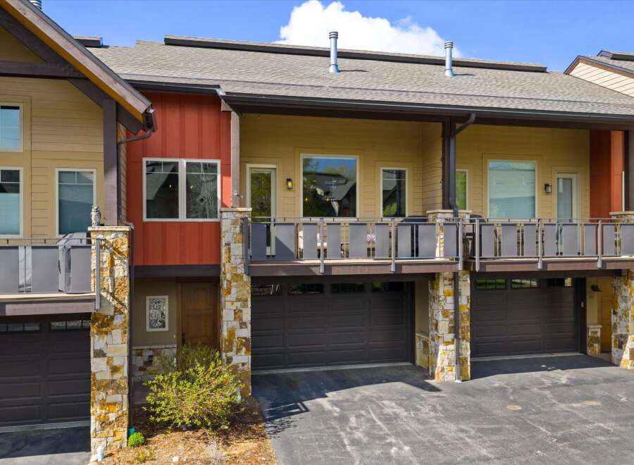 Discover modern living in this stunning property featuring a stylish exterior with a combination of stone and wood accents.