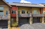 Discover modern living in this stunning property featuring a stylish exterior with a combination of stone and wood accents.