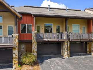 Discover modern living in this stunning property featuring a stylish exterior with a combination of stone and wood accents.