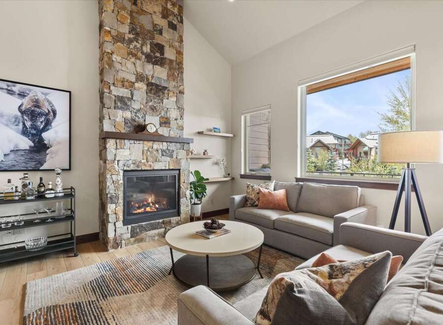 Experience luxury living in this stunning property featuring a cozy fireplace and elegant stone accents.