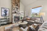 Experience luxury living in this stunning property featuring a cozy fireplace and elegant stone accents.