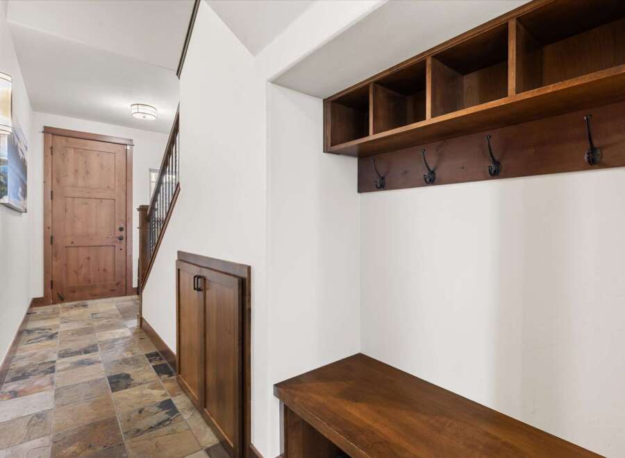 Step into this inviting entryway, showcasing a blend of rustic charm and modern design.