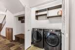 Step into this beautifully designed laundry room, featuring modern appliances and ample storage solutions.