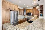 This stunning kitchen boasts beautiful wooden cabinetry and a spacious layout, perfect for both cooking and entertaining.