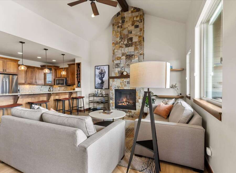 This stunning property boasts a cozy living room with a stone fireplace, perfect for relaxing evenings.