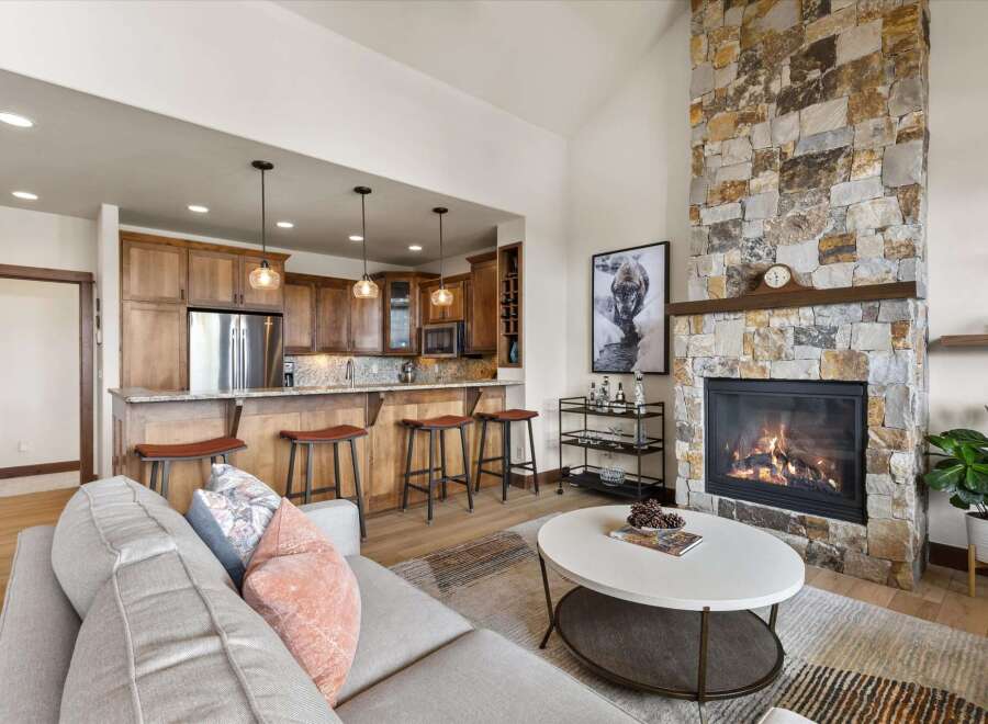 Experience luxury living in this stunning property featuring a cozy fireplace and a modern kitchen with a breakfast bar.