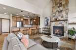 Experience luxury living in this stunning property featuring a cozy fireplace and a modern kitchen with a breakfast bar.