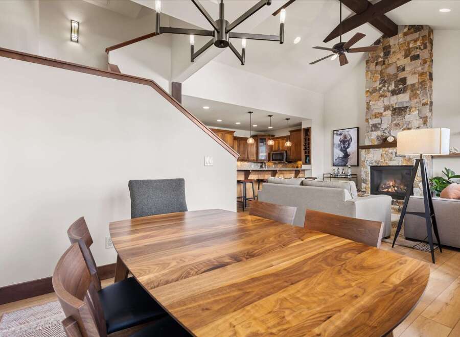 Experience luxury living in this stunning property featuring a spacious dining area with a beautiful wooden table and stylish chairs.