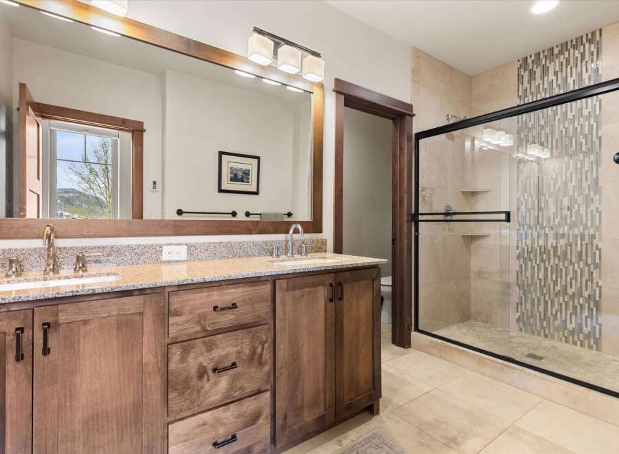 This luxurious bathroom features a spacious vanity with ample storage and a stunning granite countertop.