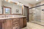 This luxurious bathroom features a spacious vanity with ample storage and a stunning granite countertop.
